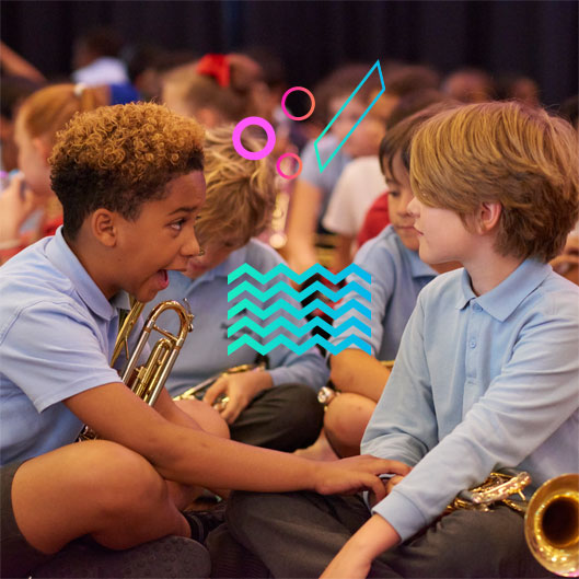 A small groups of young boys interact whilst waiting for their performance.